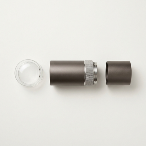 The grinder separated into its three parts: glass lid, body and grounds cup